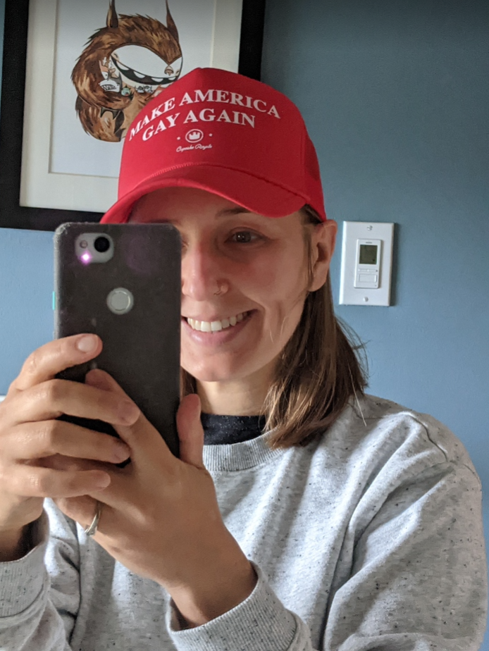 Author wearing red MAGA hat that says "Make America Gay Again"