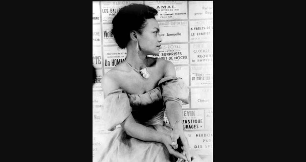 B&W picture of a young Black woman with short dark hair (Eartha Kitt) in a strapless dress, looking off to the side.